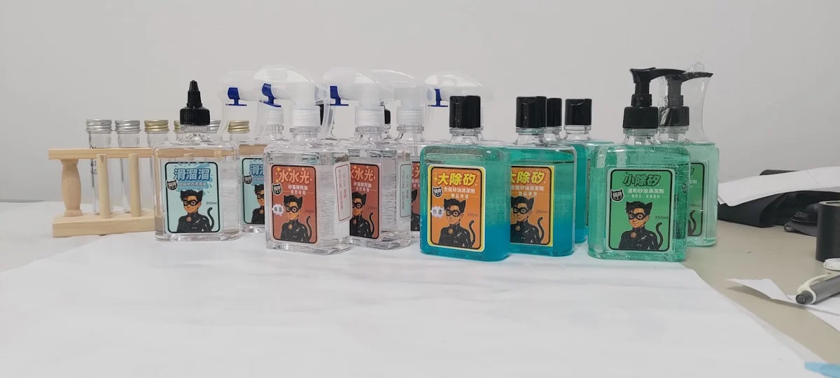 Early product bottles with the original cat-person portrait labels, arranged on a table.